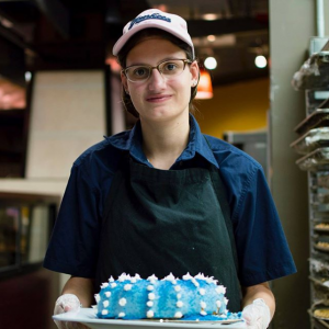 Rachel holding a cake.